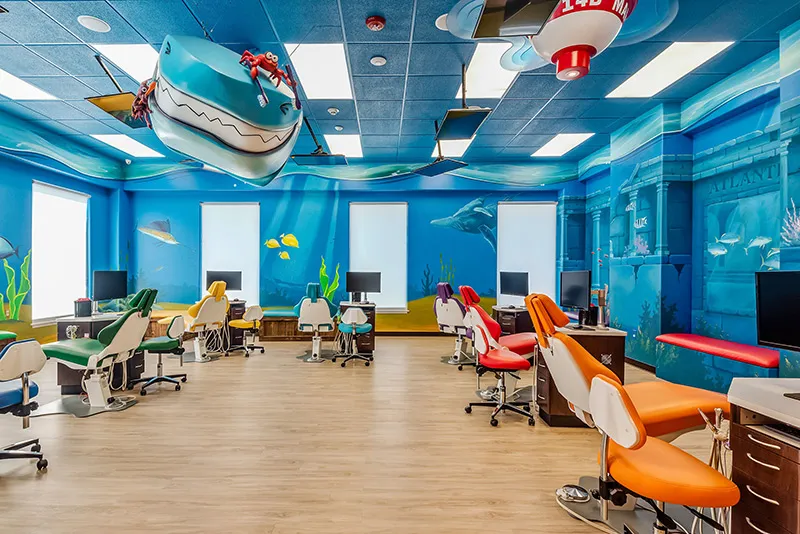 The open bay with a shark suspended from the ceiling and underwater murals